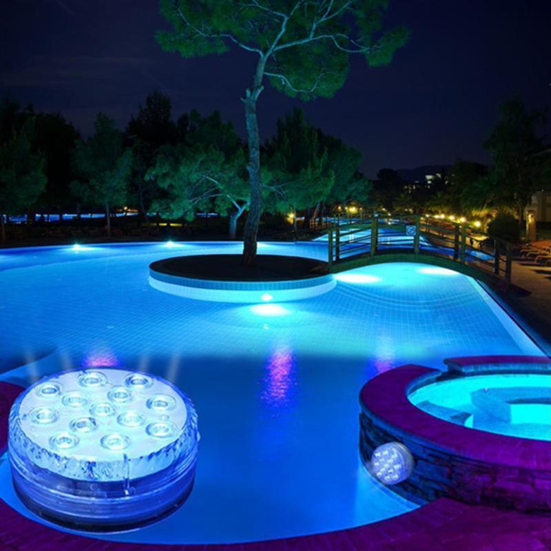 Set of multiple RGB submersible LED pool lights with remote, creating a dazzling display in water.
