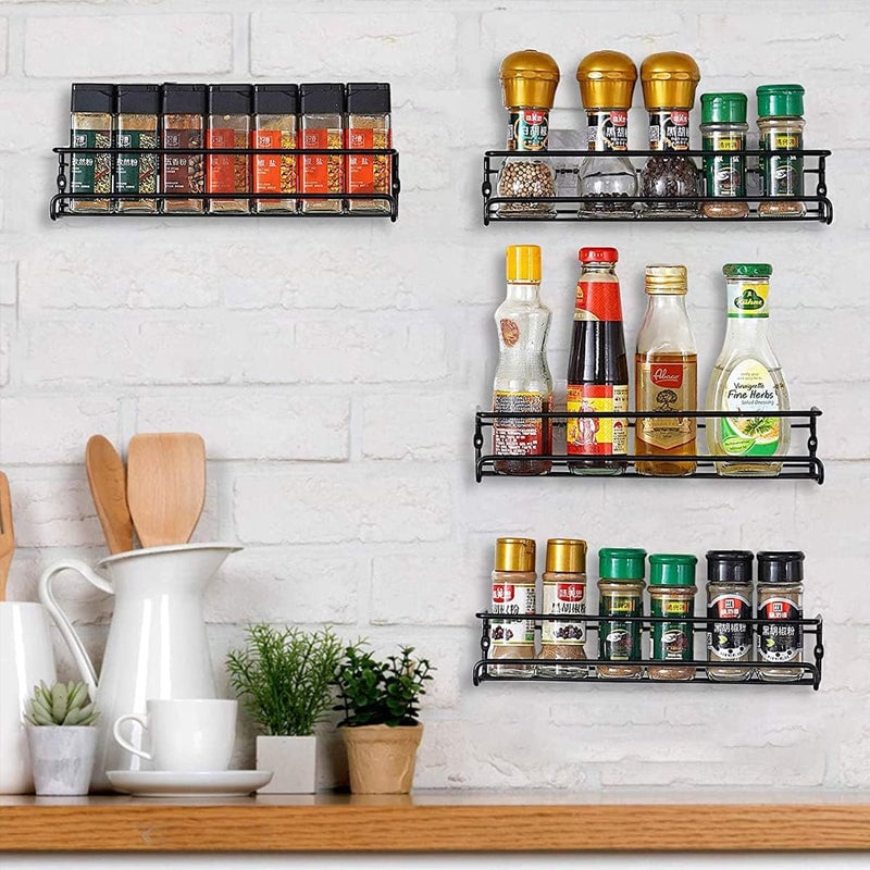 Organized kitchen cabinet featuring a wall-mounted carbon steel spice rack, saving counter space.