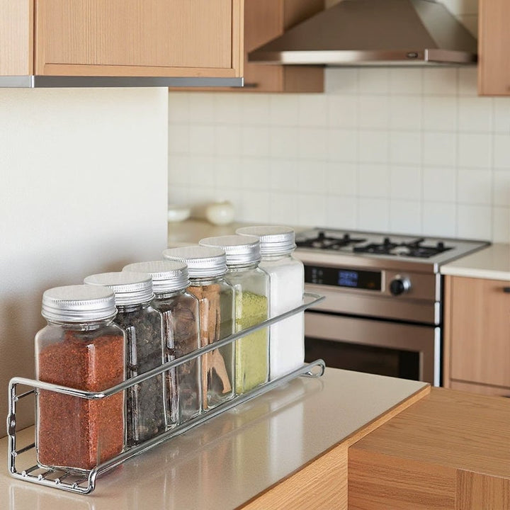 Overhead view of a filled carbon steel spice rack, showcasing accessible kitchen organization.
