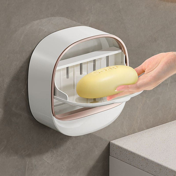 Wall-mounted self-draining soap dish in a modern bathroom, perfect for soap storage and drainage.