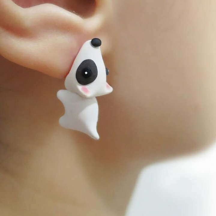 Close-up of whimsical animal bite stud earrings on a white background