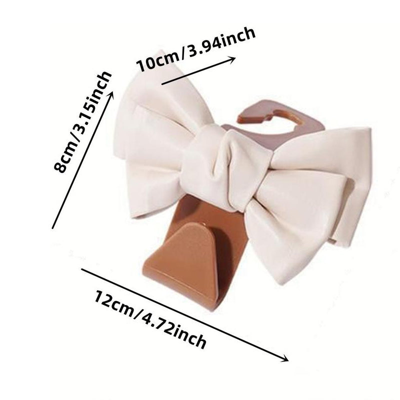 Close-up of a single bowknot car seat back hook, showcasing the design detail