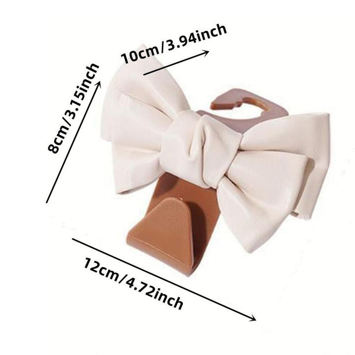 Close-up of a single bowknot car seat back hook, showcasing the design detail