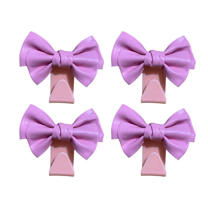 White bowknot car seat back hook from a side view, showing sturdy construction