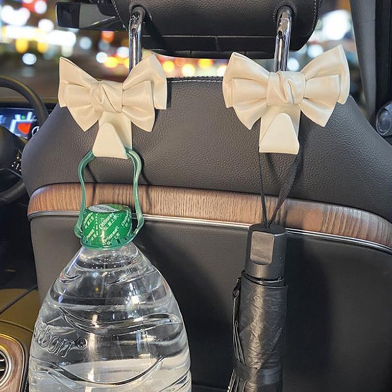 Pair of bowknot design car seat back hooks, white plastic for auto interior organization