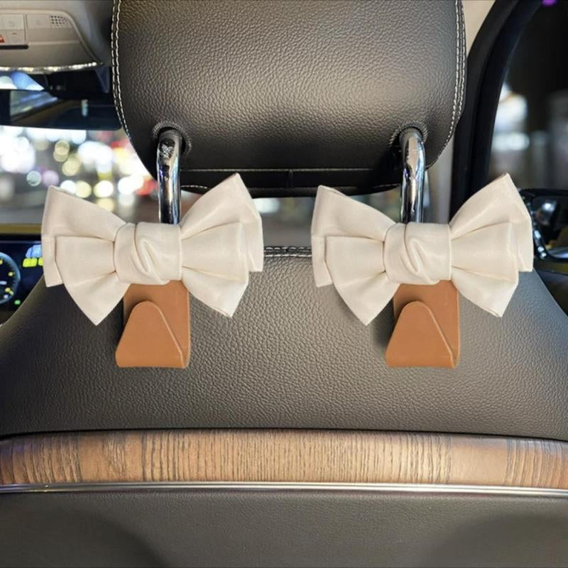 Stylish bowknot car seat hook holding a shopping bag, perfect for vehicle storage solution