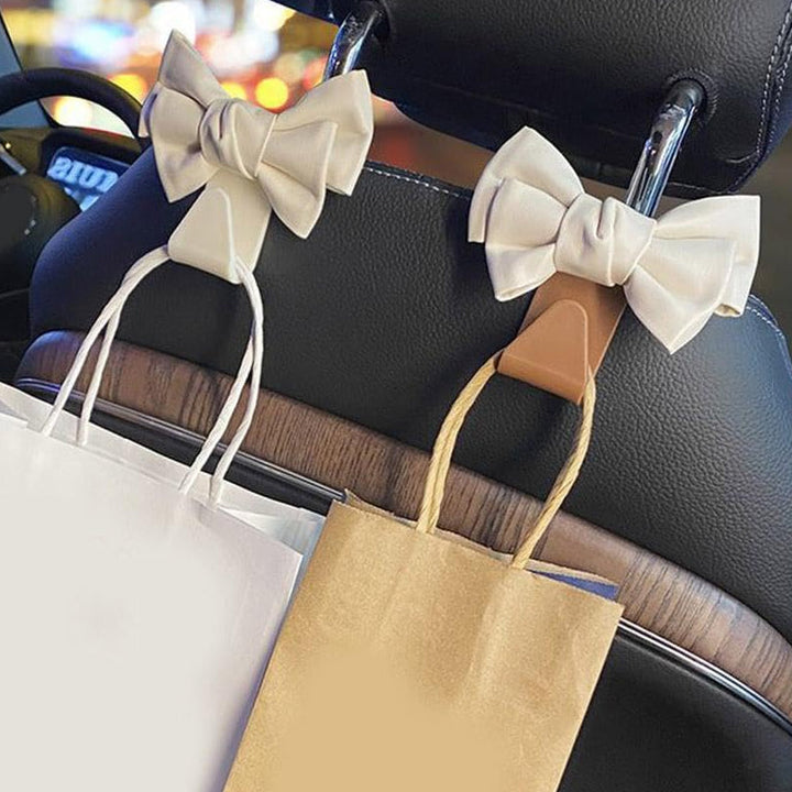 Set of two white bowknot car hooks, ideal car accessories for bags and purses
