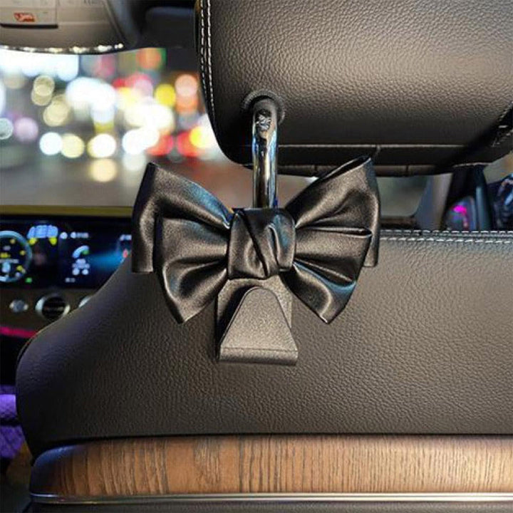 White plastic bowknot car seat back hooks, decorative yet practical vehicle storage