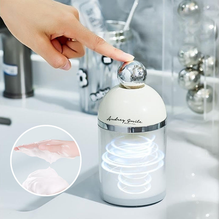 Hand holding a white electric foam maker, demonstrating its comfortable grip for daily use.