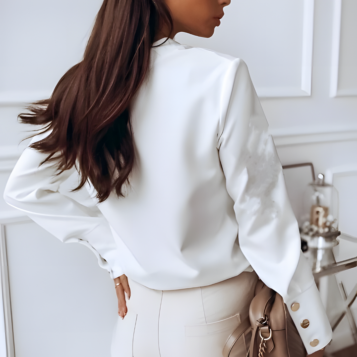 Plain white women's long sleeve button-up blouse. Ideal for summer, this casual top offers an effortless, classic look.