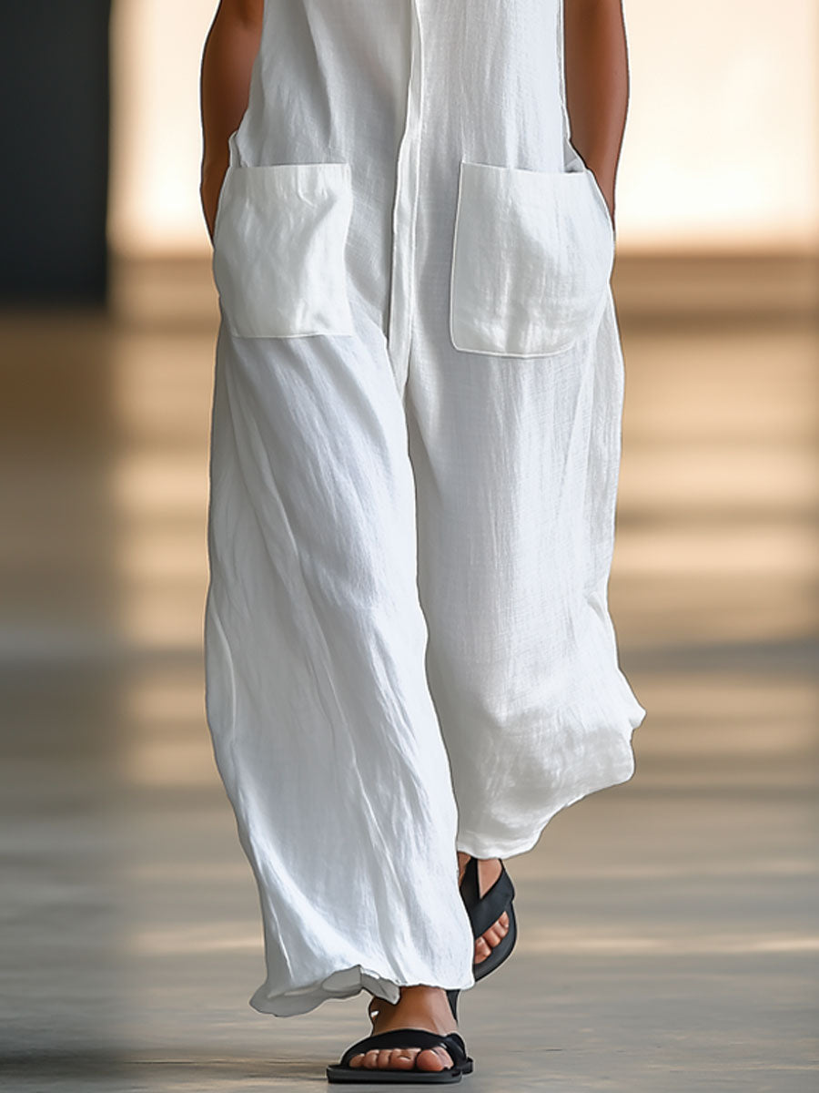 Elegant women's sleeveless jumpsuit with deep V-neck, collar, wide legs, & patch pockets. Comfortable summer resort wear.