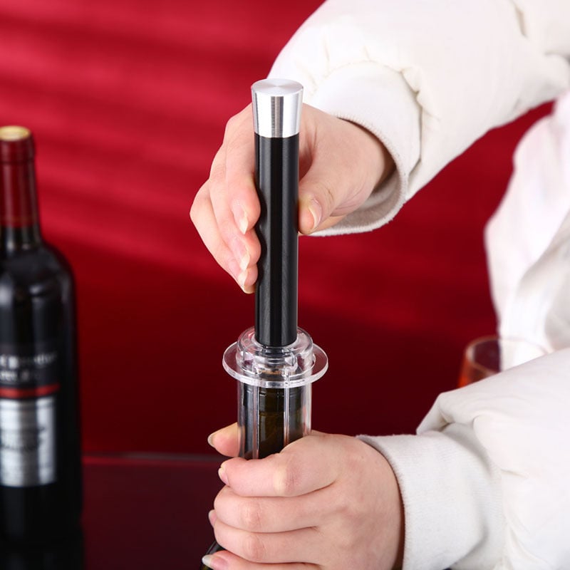 Hand holding Wino On The Go air pressure wine bottle opener, demonstrating ease of use