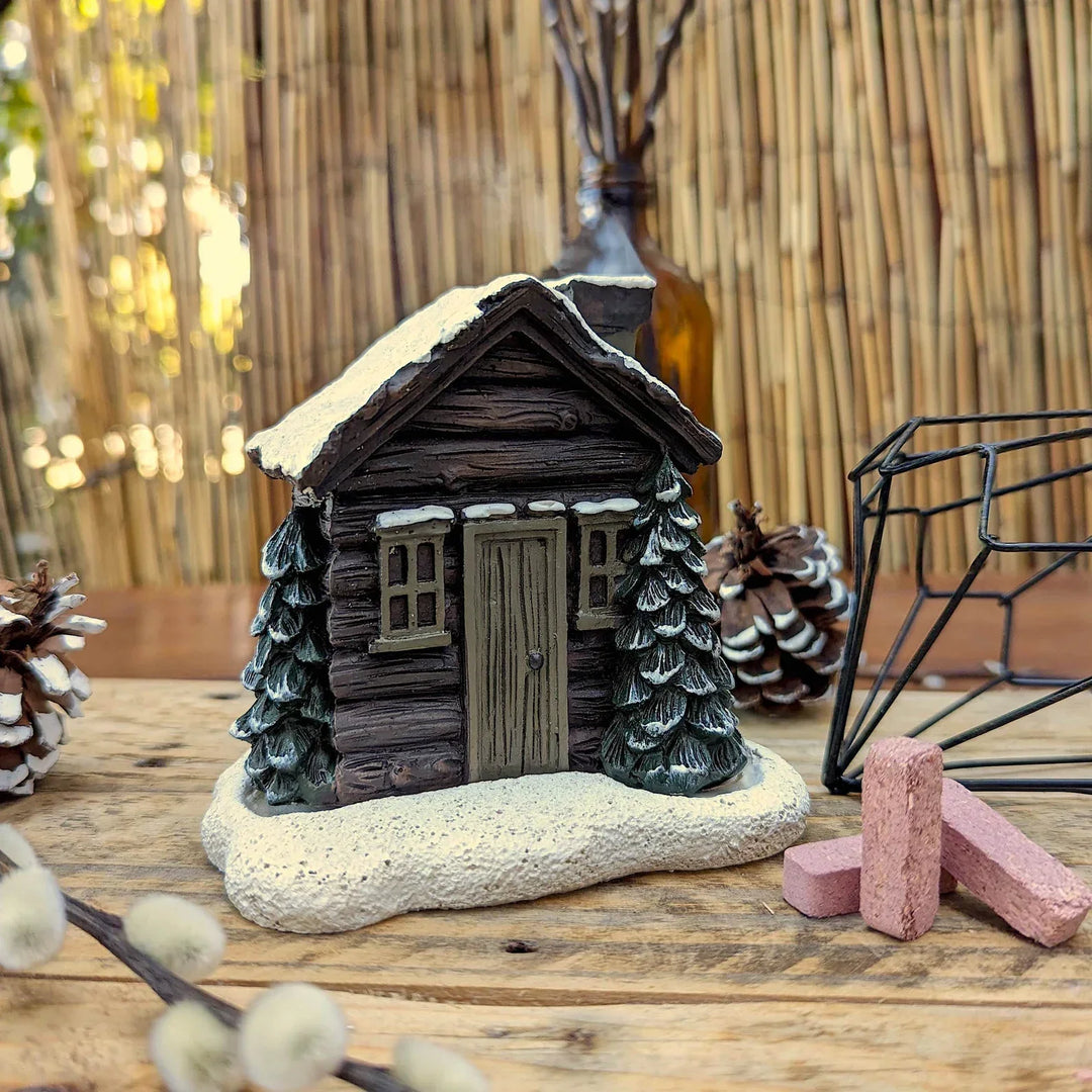 Incense Cone Burner shaped like a tiny Winter Log Cabin, creating a festive aroma
