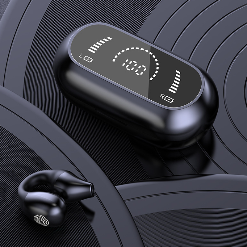 Close-up of the bone conduction ear clip, highlighting its ergonomic and lightweight design.