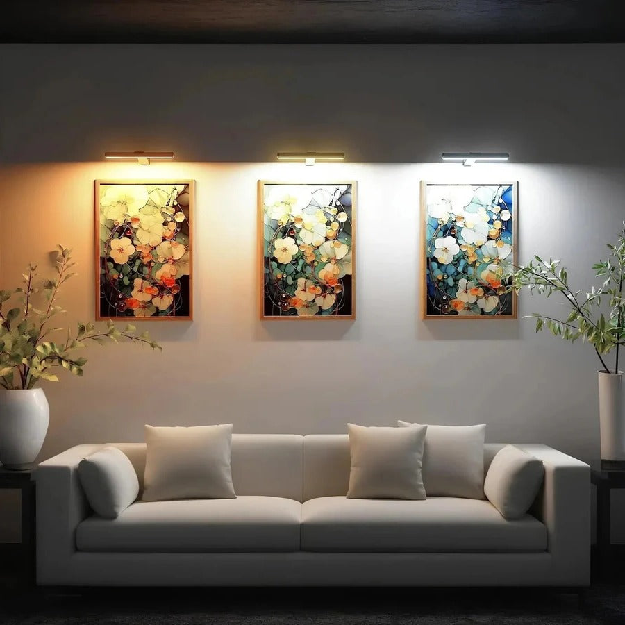 Mounted wireless LED picture light over artwork. Rechargeable, dimmable, perfect modern lighting for art display.