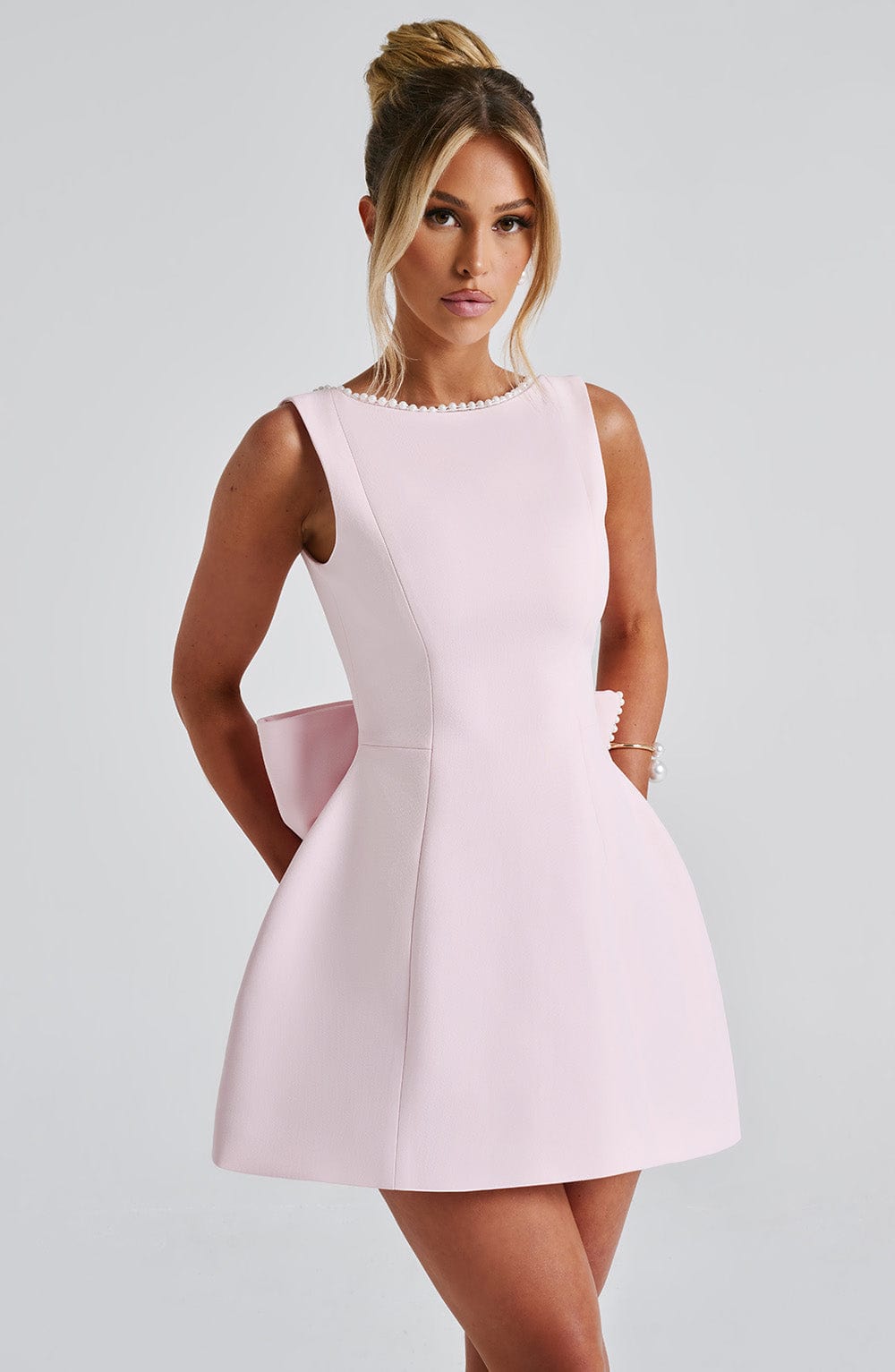 Stylish women's mini A-line dress, featuring chic pearl trim and a flattering silhouette for parties.