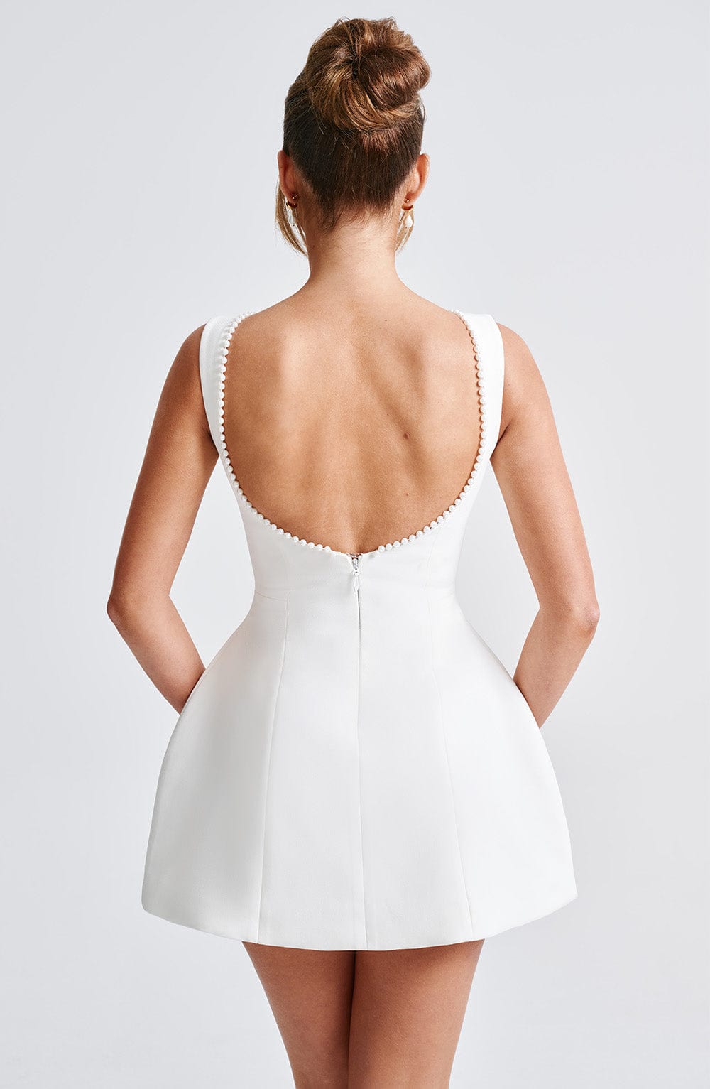 Beautifully trimmed A-line mini dress for women, featuring dazzling pearl accents. Ideal for special events.