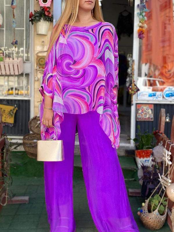 Complete women's outfit: abstract print batwing top & elegant wide-leg pants. A stylish, comfortable matching set.