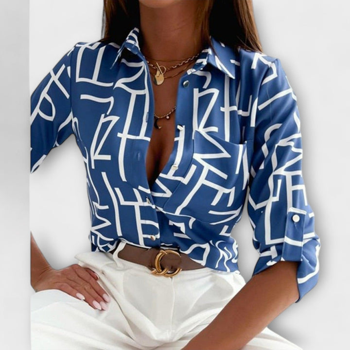 Oversized fit women's abstract print button down blouse with a chic chest pocket.