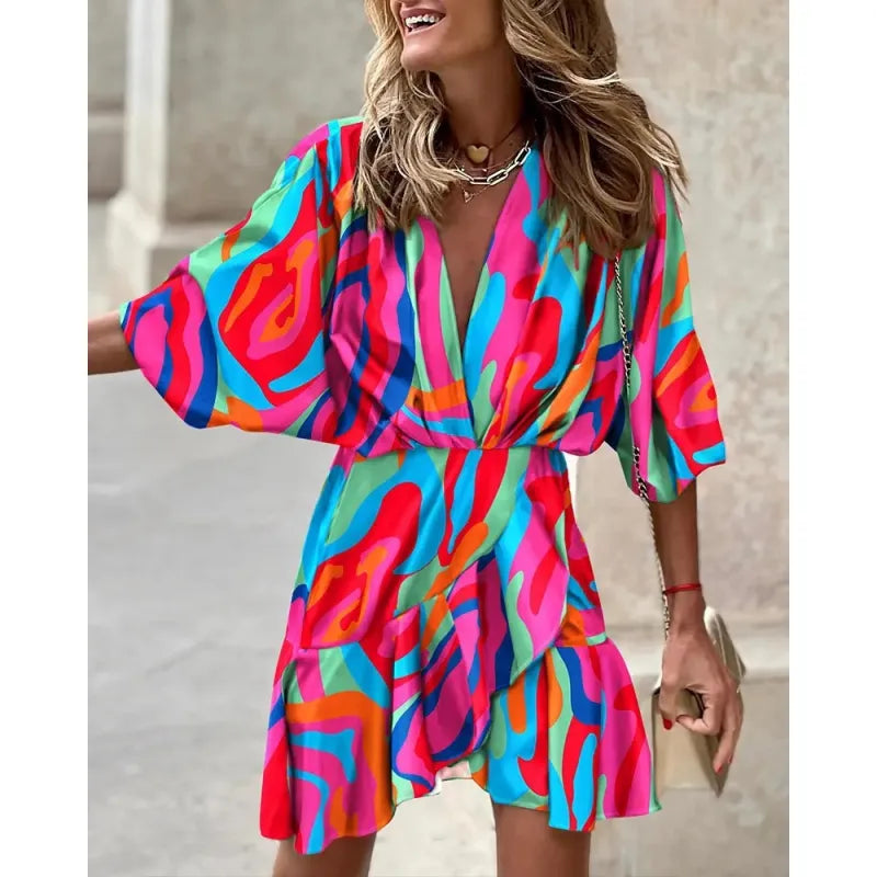 Stylish women's mini dress with an eye-catching abstract print, V-neck, and delicate ruffle trim. Flattering fit.