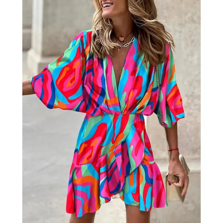 Stylish women's mini dress with an eye-catching abstract print, V-neck, and delicate ruffle trim. Flattering fit.