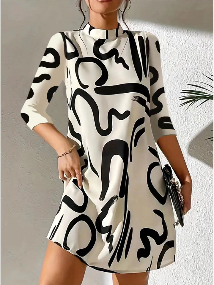 Stylish women's knee-length dress with a mock neck and unique abstract print. Three-quarter sleeves, modern casual look.