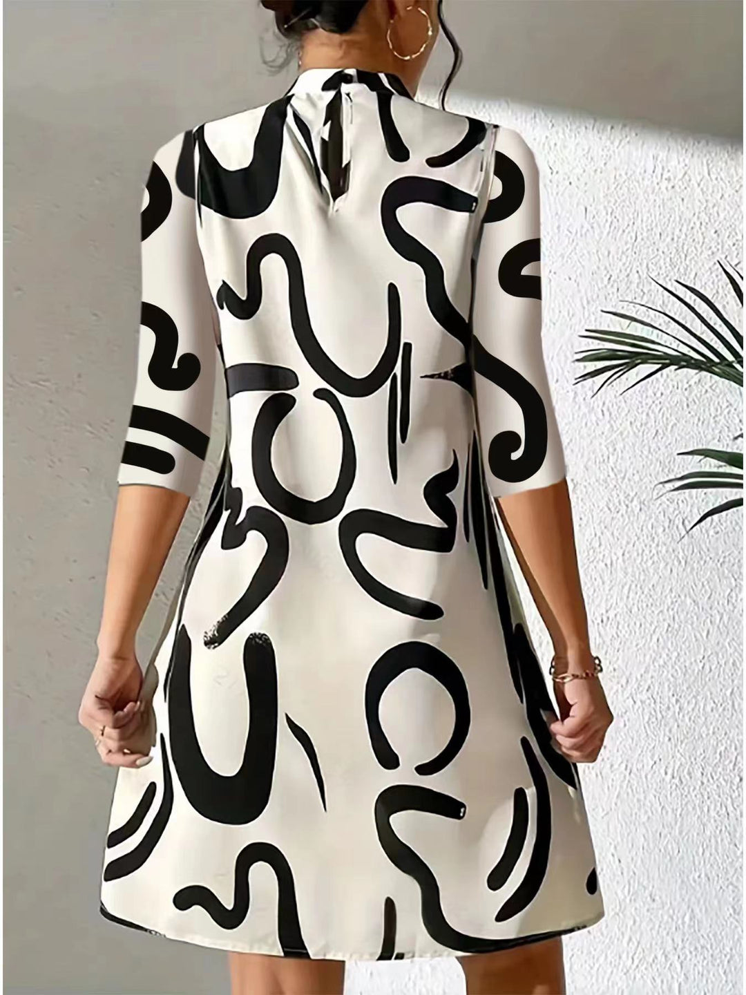 Artistic abstract print women's mock neck dress. Knee-length, loose fit, three-quarter sleeves for stylish comfort.