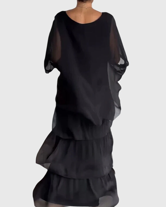 Casual women's tiered maxi dress with vibrant abstract print, perfect for summer festivals.
