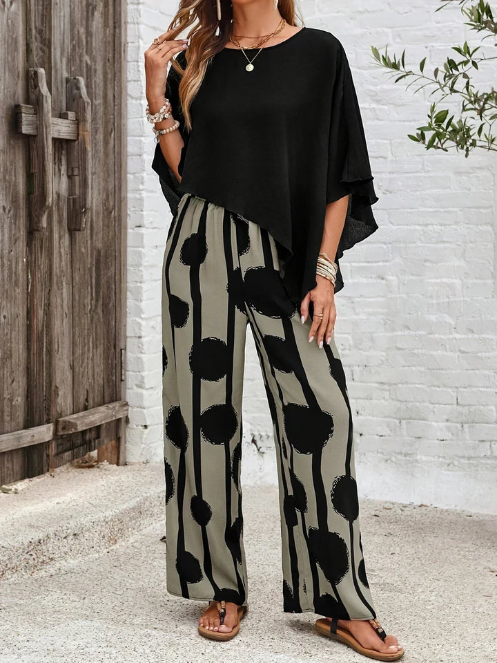 Trendy women's abstract print matching set. Features a flowy batwing top & wide leg pants for versatile wear.