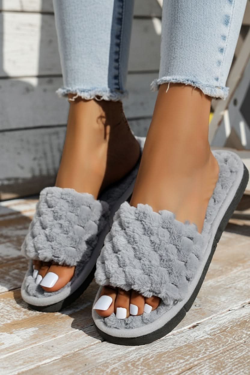 Women's adjustable open-toe comfort slippers in a cozy home setting.