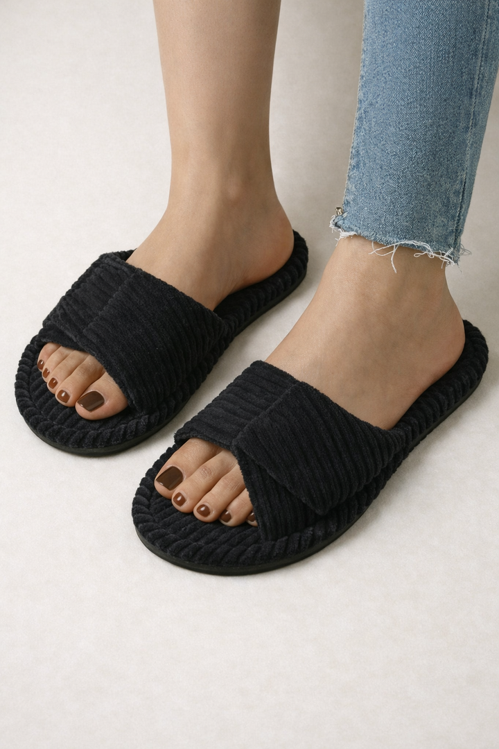 Top-down view of a pair of women's cushioned open-toe slippers.