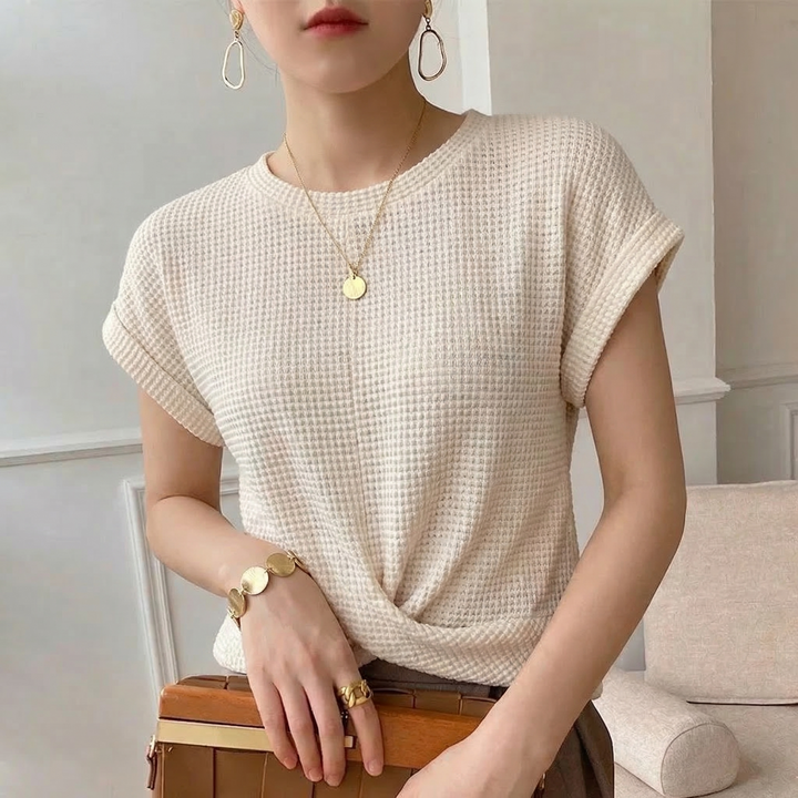 Elegant women's amber long sleeve top featuring a unique textured finish and fashionable twist front detail.