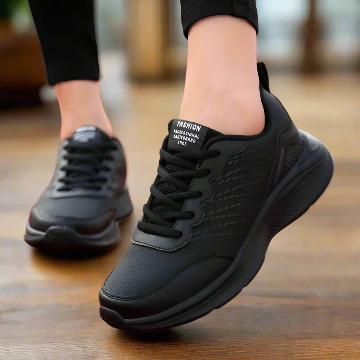 Women's anti-slip work shoes in black, featuring ergonomic design and breathable material for ultimate comfort & safety.