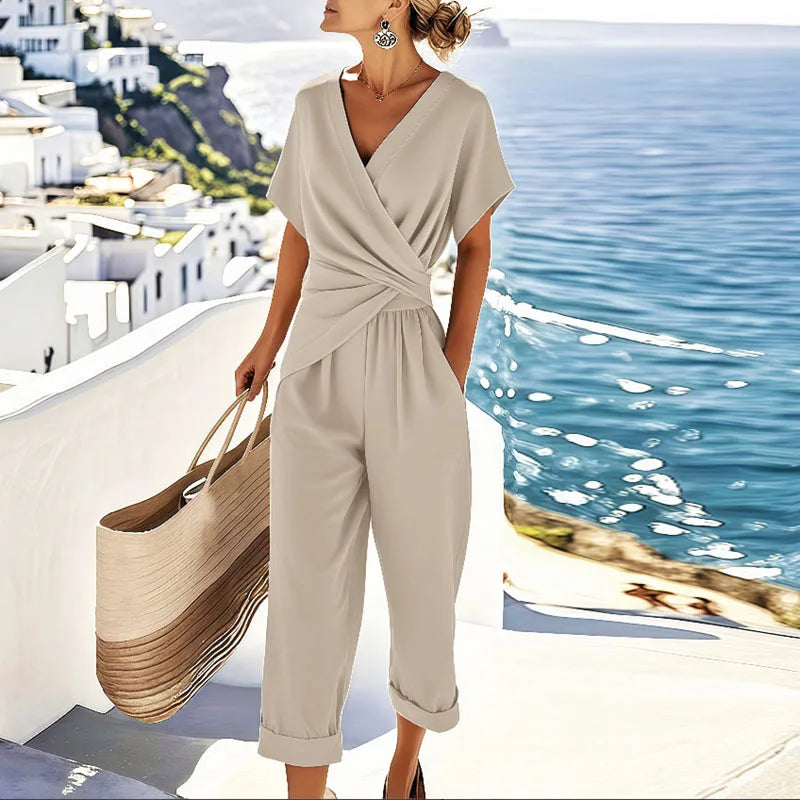 Women's apricot flowy wrap jumpsuit with V-neck, tie waist & wide leg. Perfect for summer vacation.