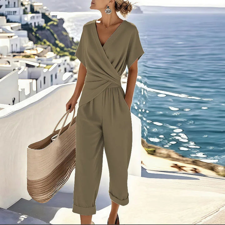 Khaki women's effortless flowy wide-leg jumpsuit with V-neck & tie waist. Comfortable summer fashion.