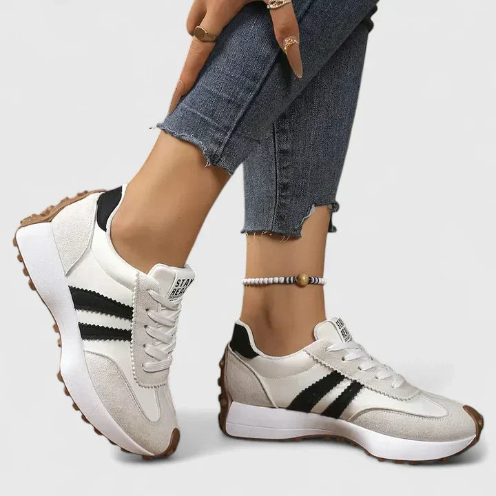 Comfortable women's gym sneakers. Black athletic footwear with a supportive chunky sole for active workouts.