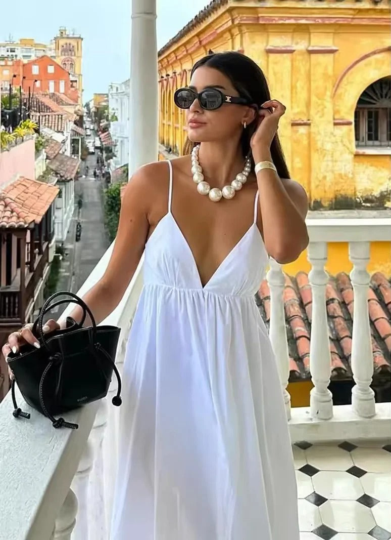 Women's backless spaghetti strap maxi summer dress. Flowy V-neck for beach or vacation.