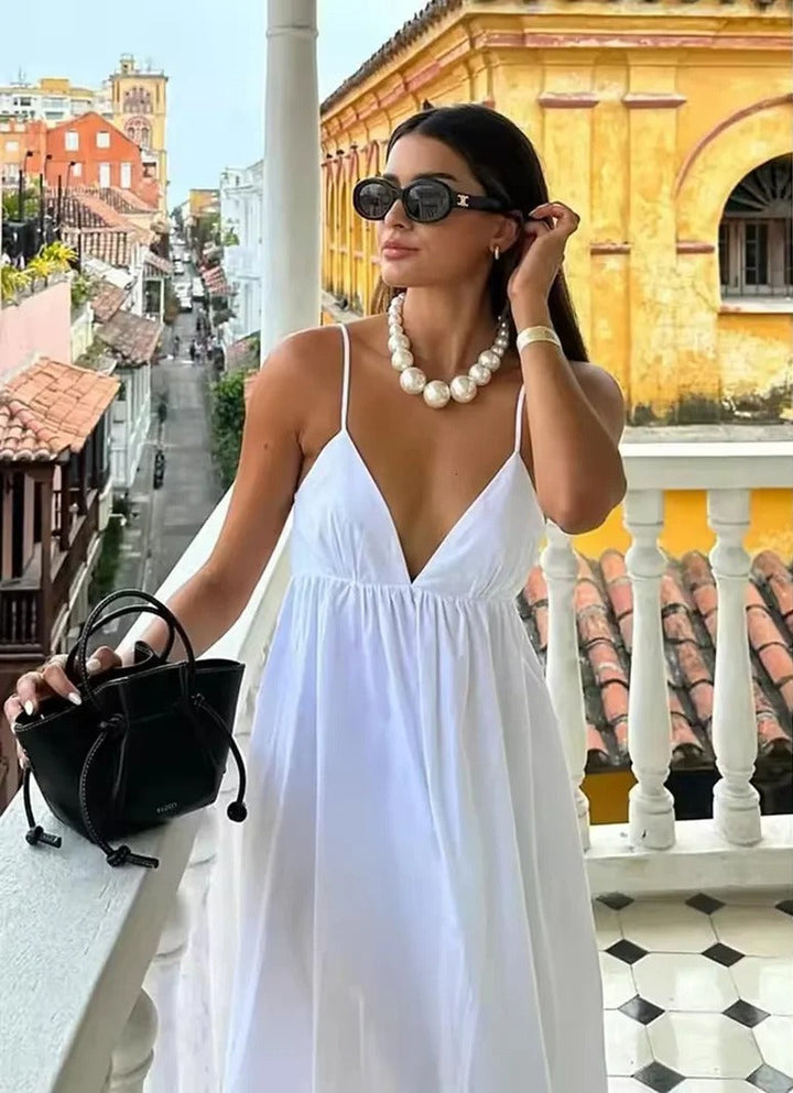 Women's backless spaghetti strap maxi summer dress. Flowy V-neck for beach or vacation.