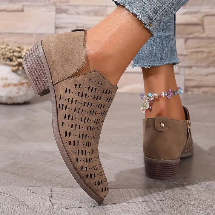 Close-up of a women's casual cutout ankle boot in beige, highlighting the perforated details and comfortable fit