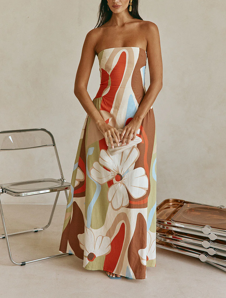 Women's beige strapless maxi dress featuring an abstract floral print, chic for summer & resort style.