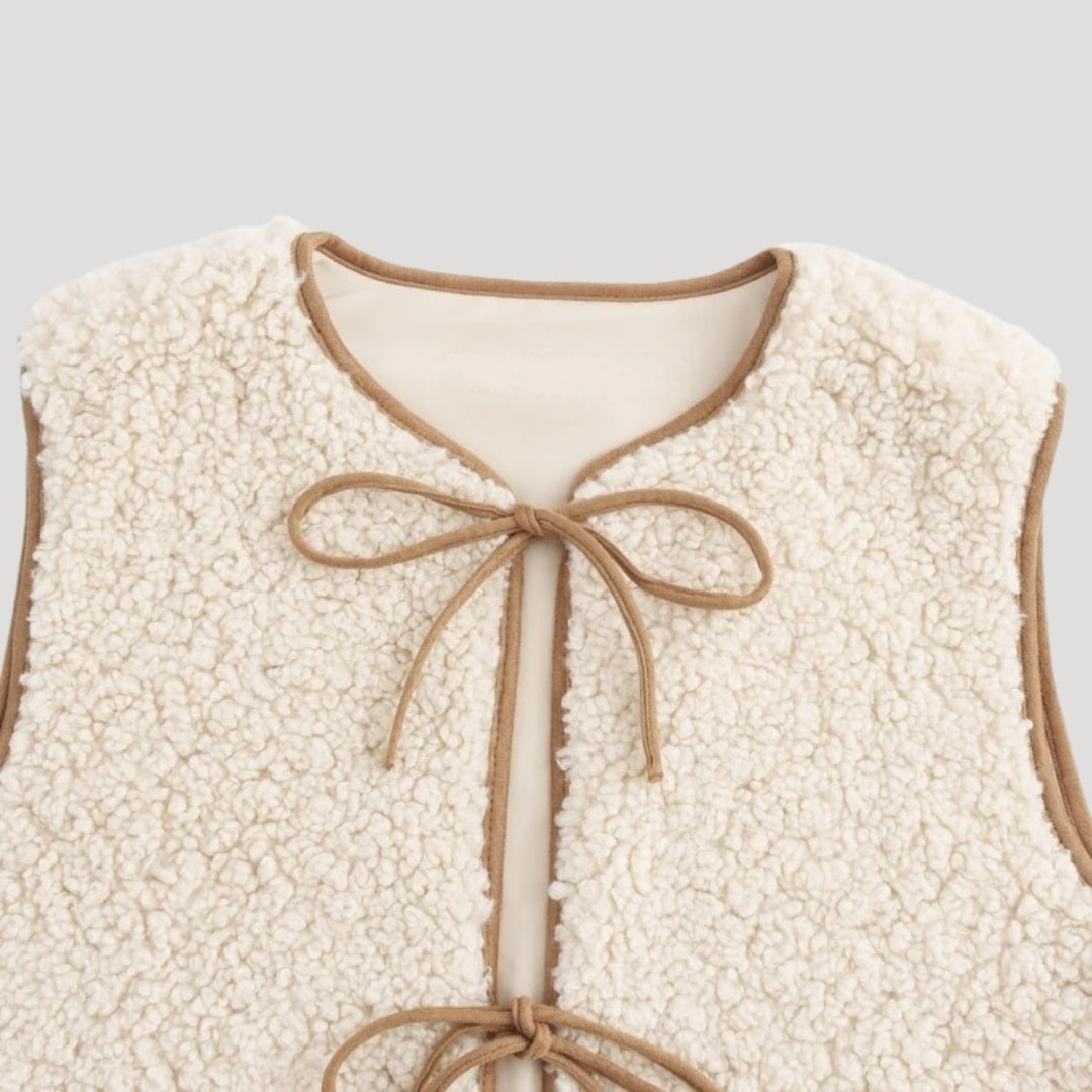 Cozy beige tie-front vest for women, ideal for spring fashion and layering.