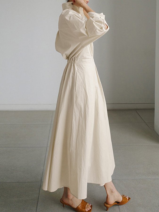 Front view of a women's shirt maxi dress, featuring a stylish belt and full length