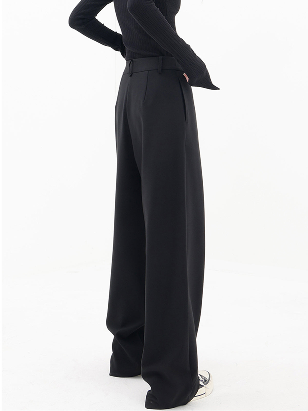 Women's black asymmetric baggy trousers, a relaxed fit pant for modern, casual wear.