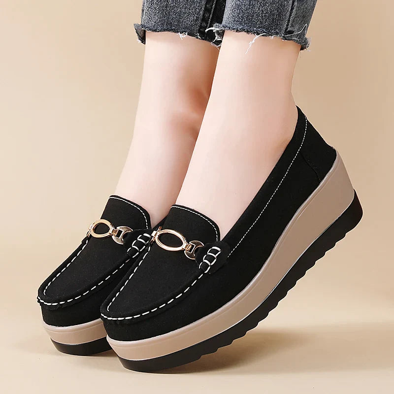 Lifestyle shot of a woman wearing black comfort platform loafers, perfect for everyday style