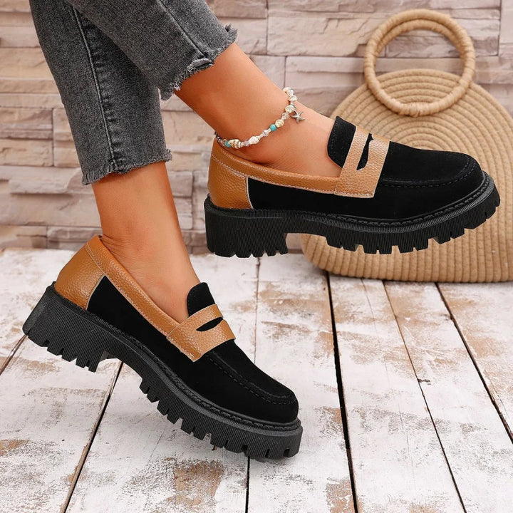 Pair of women's slip-on platform loafers in black, perfect for comfort footwear