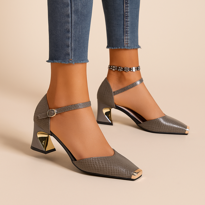 Fashionable women's ankle strap block heels in croc pattern with a distinctive metal tip design