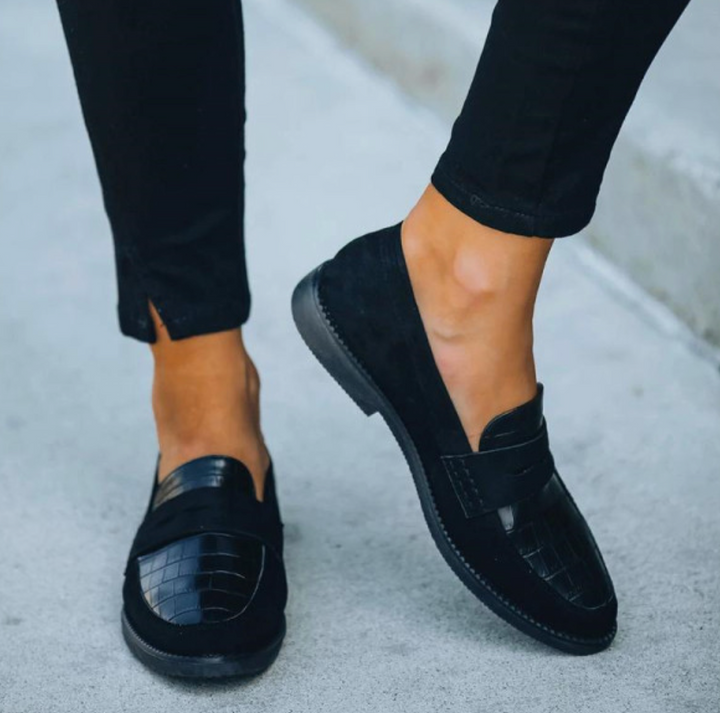 Pair of women's comfortable slip-on loafers featuring a sophisticated crocodile texture pattern
