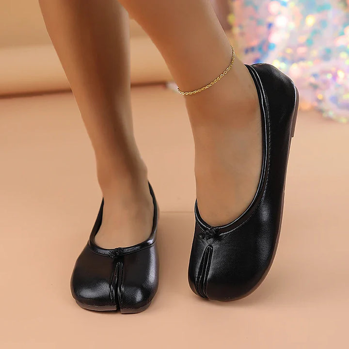 Sophisticated women's flats: black faux leather, split toe, and easy slip-on style.