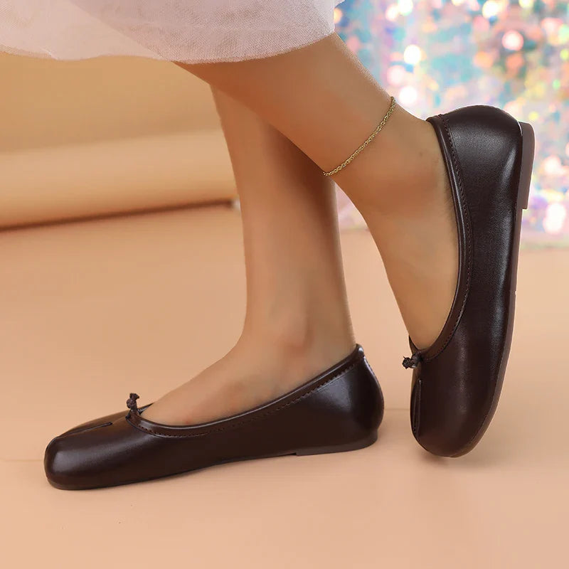 Black faux leather women's flats with a trendy split toe for contemporary style.