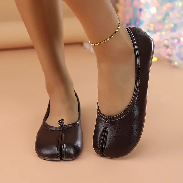 Fashion-forward women's flats: black, faux leather, and a unique split toe.